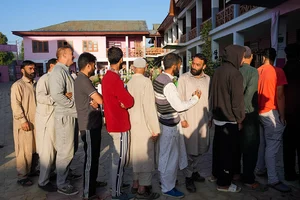 | Photo: PTI/S Irfan : People wait in a queue to cast their votes at Handwara in Kupwara district