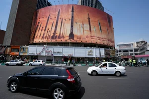 Vehicles drive past an anti-Israeli banner showing missiles being launched, in a square in downtown Tehran, Iran (representative image)