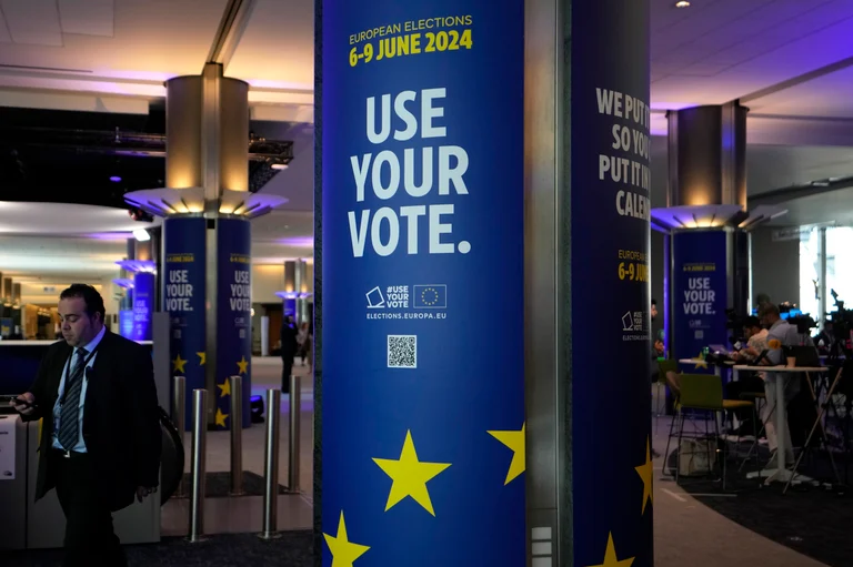 A man walks through a hallway during a voting night event at the European Parliament in Brussels - Associated Press