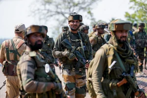 AP Photo : Indian army soldiers patrol the area where a bus fell into a deep gorge in Reasi district