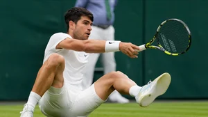 AP Photo/Alberto Pezzali : Carlos Alcaraz of Spain falls during his fourth-round match against Ugo Humbert of France at the Wimbledon tennis championships in London.