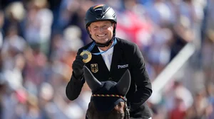 AP/Mosa'ab Elshamy : Gold medal winner Michael Jung from Germany celebrates after winning the equestrian individual competition at the 2024 Summer Olympics, Monday, July 29, 2024, in Versailles