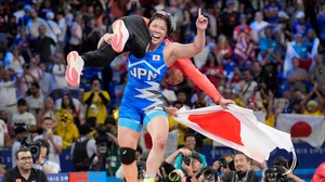 AP/Eugene Hoshiko : Japan's Yuka Kagami celebrates after defeating Kennedy Alexis Blades, of the United States, in their women's freestyle 76kg final wrestling match.