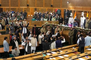 AP Photo : Bharatiya Janata Party (BJP) lawmakers protest inside the Jammu and Kashmir Assembly in Srinagar