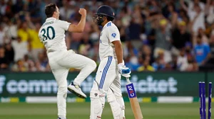 Photo: AP/James Elsby : Pat Cummins celebrates the wicket of Rohit Sharma during day 2 of the second India vs Australia Test in Adelaide.