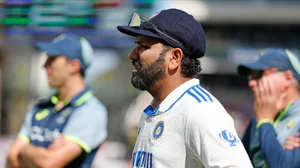 AP Photo/James Elsby : India's captain Rohit Sharma reacts during the presentation ceremony of the second cricket test match between Australia and India at the Adelaide Oval.