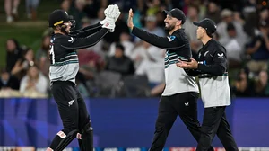 Andrew Cornaga/Photosport via AP : New Zealand's Mitch Hay and Daryl Mitchell celebrate the dismissal of Sri Lanka's Kusal Mendis during the second T20I in Mount Maunganui.