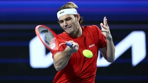 AP : Taylor Fritz of the United States hits a return shot to Zhizhen Zhang of China during their United Cup tennis match in Perth.