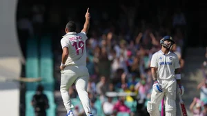 AP Photo/Mark Baker : Australia's Scott Boland, left, celebrates after dismissing India's Virat Kohli, right, during play on the second day of the fifth cricket test between India and Australia at the Sydney Cricket Ground.