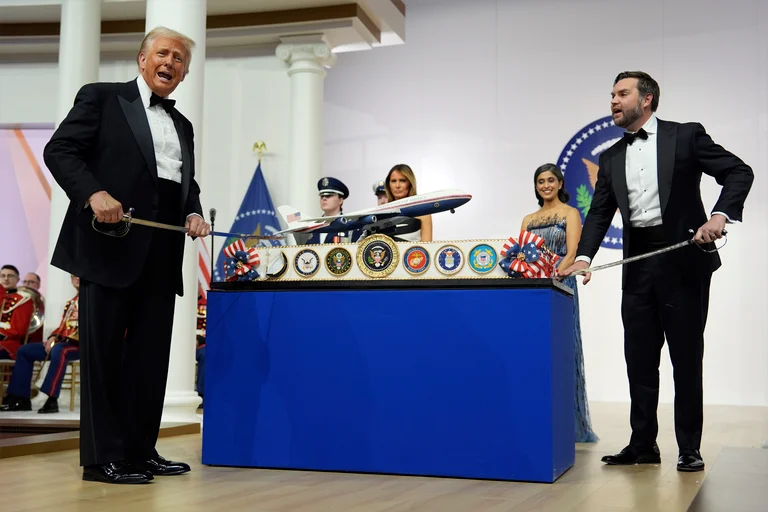 President Donald Trump and Vice President JD Vance hold sabre's before cutting a cake at the Commander in Chief Ball, part of the 60th Presidential Inauguration - AP