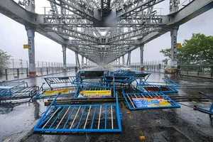 The collapsed police barricades at Howrah Bridge after strong winds due to Cyclone Amphan, at Howrah Bridge, in Howrah. (PTI)