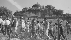 Pilgrims take a Parikarma of Babri Masjid and Ram Janma Bhoomi through barbed fencing at Ayodhya