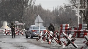 Ukrainian soldiers stand on a check-point close to the line of separation from pro-Russian rebels