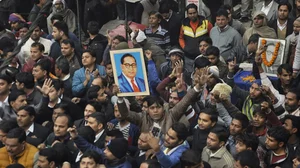 Protestors with a photo of BR Ambedkar, a symbol of the Dalit community.