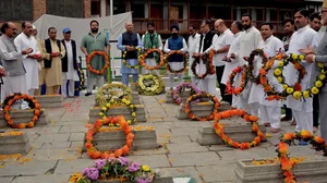 Officials lay wreaths on graves at Martyr's graveyard in Srinagar on 13 July 2018 on 'Martyrs' Day'