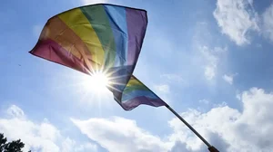 A woman waves a rainbow flag, during the annual pride march 