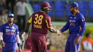 West Indies' Devon Thomas shakes hands with India's captain Rohit Sharma at the end of their second T20I match.