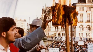 People burning a copy of The Satanic Verses.