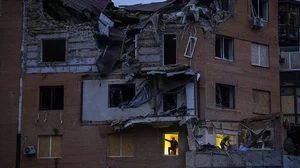 People check the damage at their apartments hit by a Russian missile in Mykolaiv.