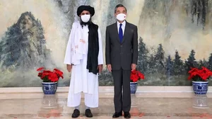 Taliban co-founder Mullah Abdul Ghani Baradar left, and Chinese Foreign Minister Wang Yi