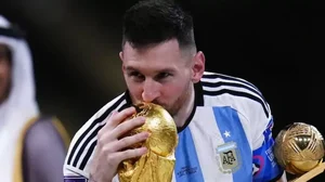 Lionel Messi kissing the World Cup trophy at Lusail Stadium, Qatar