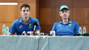 Coach Andrew McDonald, right, and Pat Cummins.