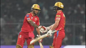 Dhawan, left, is congratulated by Sam Curran after reaching his fifty on Monday.