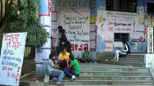 Jadavpur University students sitting on stairs. 