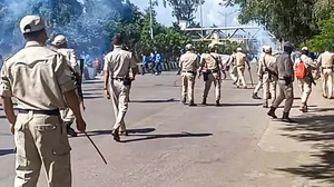 Security personnel stand guard during a protest against the killing of two youths who were allegedly kidnapped in July, in Imphal, Manipur.