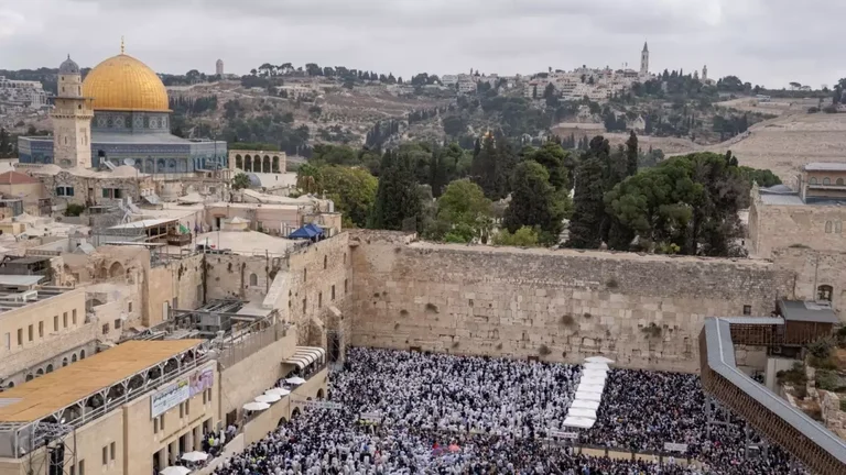 Jews take part in priestly blessing during the weeklong holiday of Sukkot in front of the Western Wall, the holiest site of Jews in Jerusalem. (AP Photo/Ohad Zwigenberg) - null