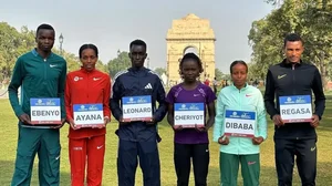 Chala Regasa (extreme right) poses along with other athletes ahead of the Delhi Half Marathon 2023.