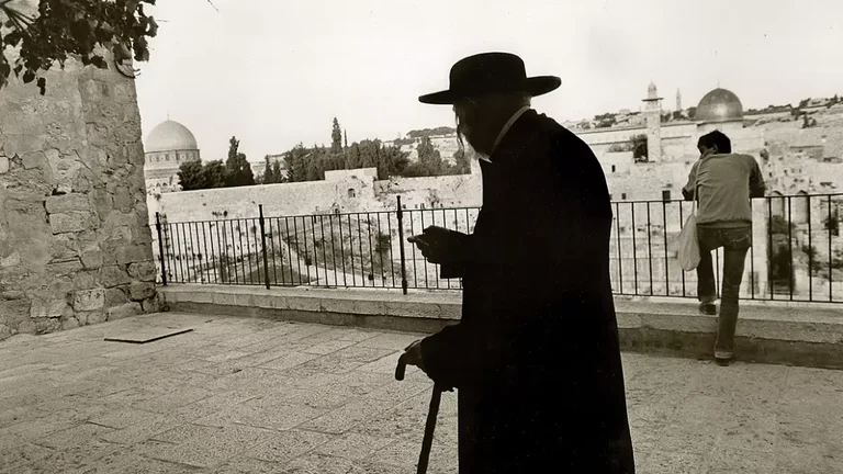 Caught in the Crossfire: An elderly Jewish man walks in Jerusalem - null