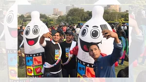 People take selfies with blowed up condoms during an event to mark International Condom Day in New Delhi on February 13, 2018.