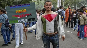 A participant of the ‘Delhi Queer Pride Parade 2023’ holds a placard in support of the Palestinians amid the Israel's War on Gaza Strip.