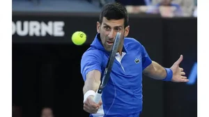 Serbia's Novak Djokovic plays a backhand return during an exhibition match against Stefanos Tsitsipas of Greece ahead of the Australian Open tennis championships at Melbourne Park, Australia.