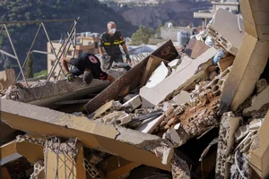 AP : Rescue workers search for victims in a rubble of a destroyed building in Lebanon |