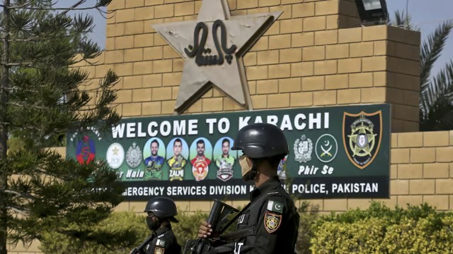 File : Pakistan police commandos stand guard outside the National Stadium in Karachi, during a training session of the Pakistan cricket team.