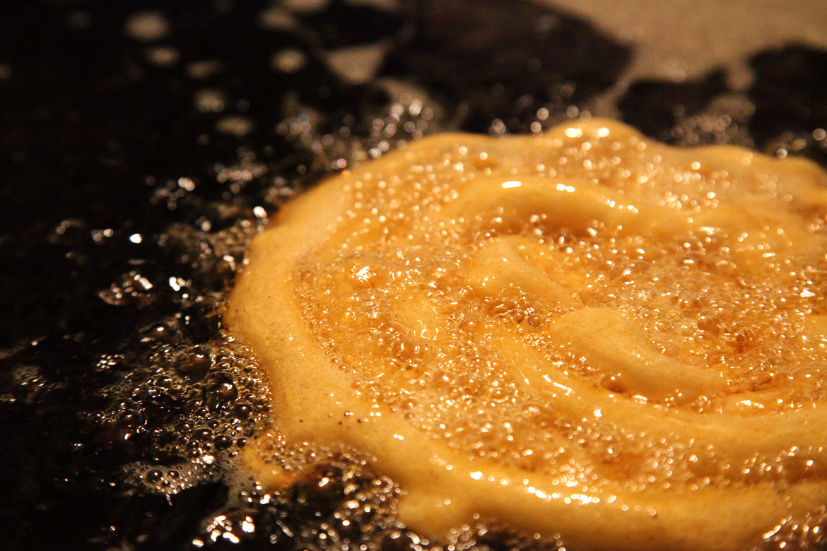 Jalebis being deep-fried at a roadside stall