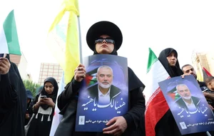 PTI : Iranians hold pictures of late Hamas Leader Ismail Haniyeh during a protest