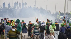 PTI : Farmers run for cover after police used teargas to disperse them during their protest at the Shambhu border, in Patiala district, Sunday, Dec. 8, 2024. 