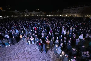 AP : Participants in a silent prayer stand with candles for the victims of the attack in Germany