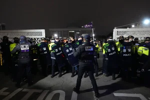 AP Photo/Lee Jin-man : Police officers stand guard in front of the National Assembly in Seoul, South Korea, Tuesday, Dec. 3, 2024.