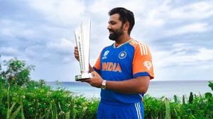 Photo: X/ @BCCI : Rohit Sharma looking at the T20 WC trophy.