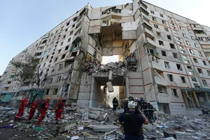 | Photo: AP/Andrii Marienko : Russia Ukraine War: Emergency workers stand amidst the rubble in Kharkiv