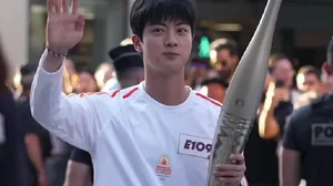 X : BTS' Jin with the Olympic torch