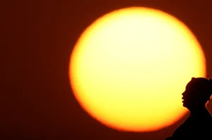 AP : A woman is silhouetted against the setting sun in the Midwest in Kansas City |