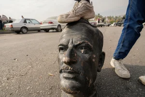 AP Photo/Hussein Malla : An opposition fighter steps on a broken bust of the late Syrian President Hafez Assad in Damascus, Syria, Sunday Dec. 8, 2024. 