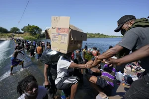 Haitian migrants use a dam to cross to and from the US from Mexico.