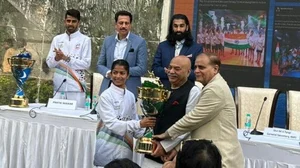 Special Arrangement : Indian women's team captain Priyanka Ingle hands over the Kho Kho World Cup trophy to KKFI president Sudhanshu Mittal. 