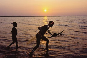 Photo: Getty Images : In Isolation: Jarawas fishing 
on a coral reef 